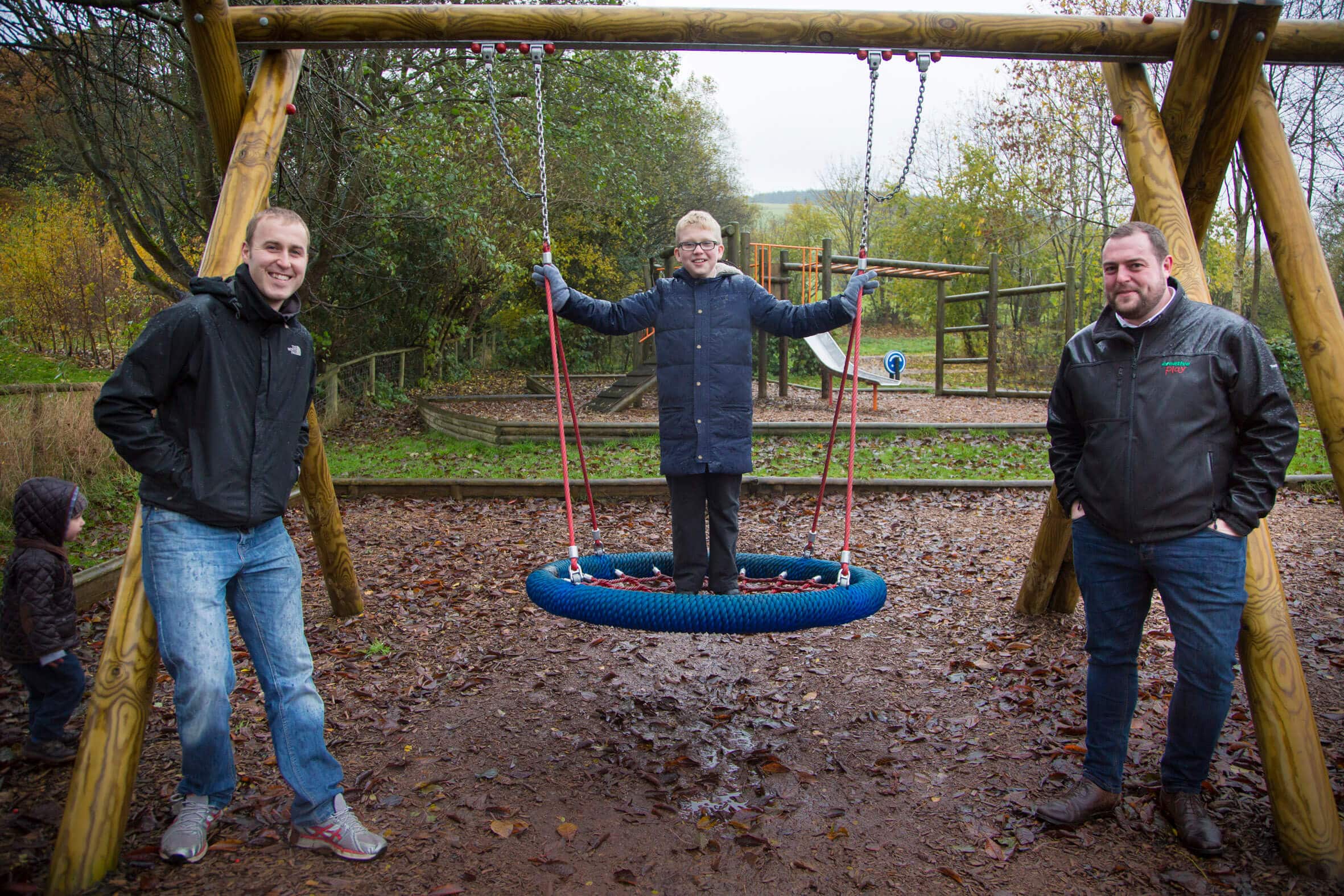 Jack Roberts, 10 Who Officially Opened The New Playground In Llanferres Pictured With Gareth Jaggard, Secreatary Of The Playing Field Association And Rob Williams Sales Manager From Creative Play.