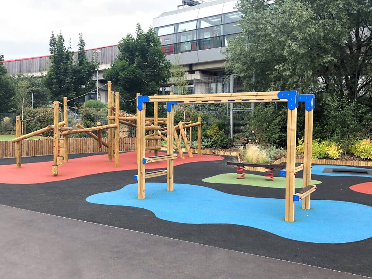 Wooden monkey bars on a soft and colourful playground floor