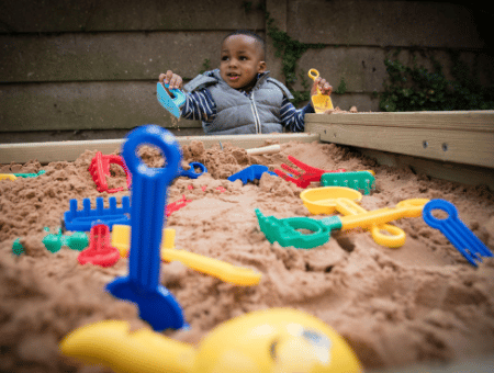 Child playing in sand pit