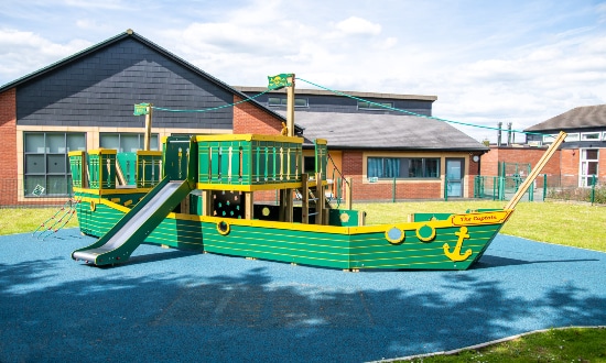 Childrens play area in the form of a green wooden boat called The Captain