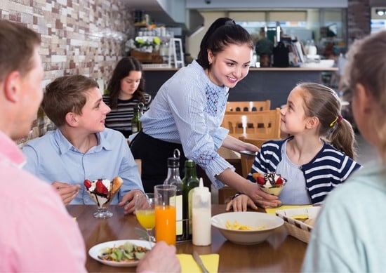 Family being served by a waitress indoors