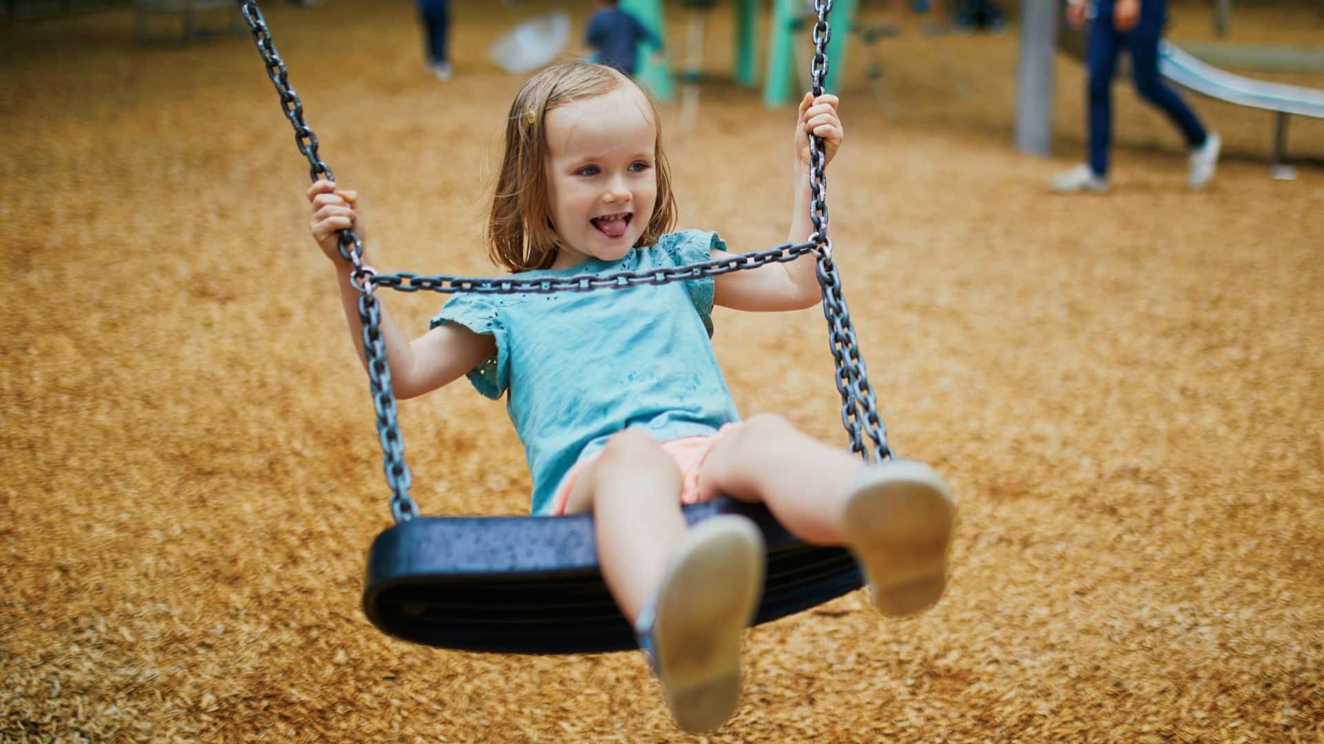 Little girl on a swing in the park