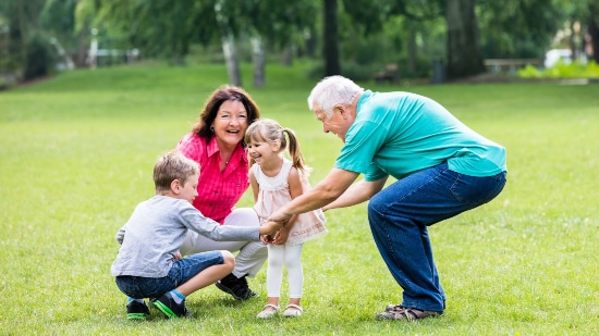 Older couple with two kids in the park