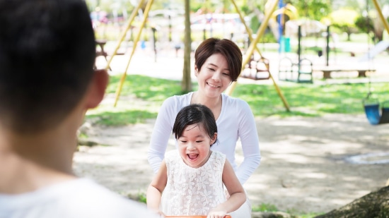 Happy mother and daughter in a playground