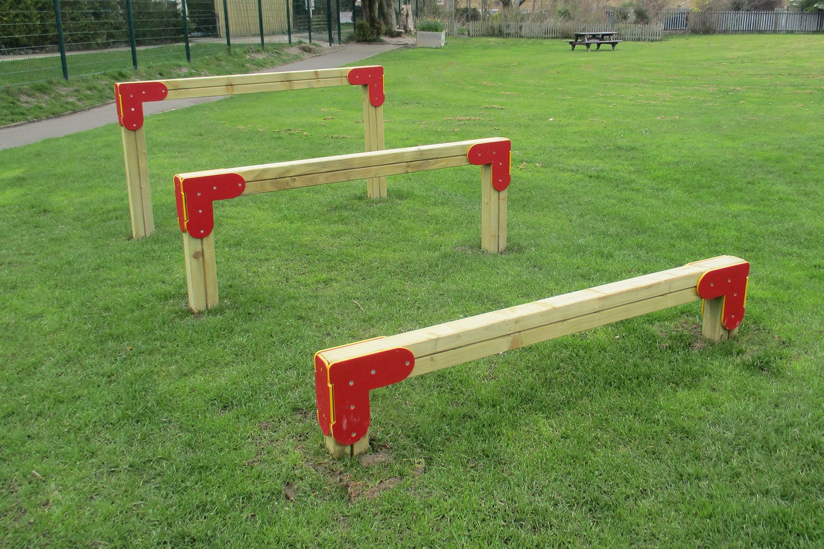 Three wooden hurdles on grass