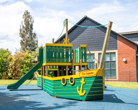 Green wooden ship in a playground