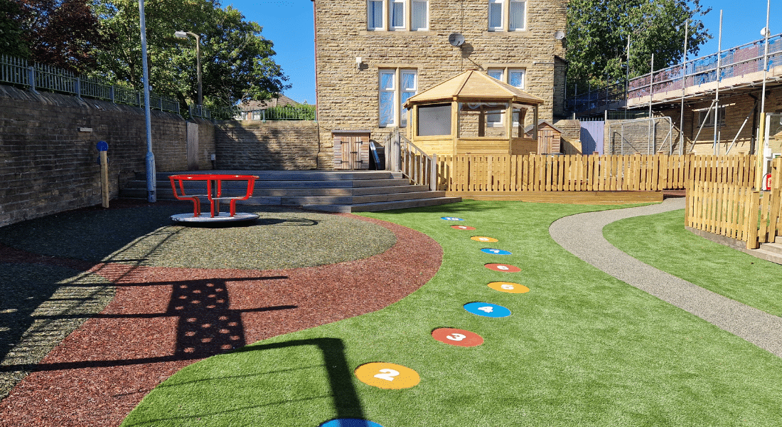 Spinner With Seating, Octavia Outdoor Classroom Playground Equipment with Artificial Grass And Wetpour Safety Surfacing
