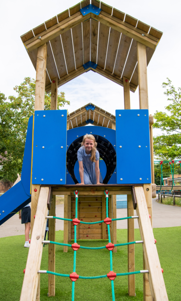 child using playground tower in school playground