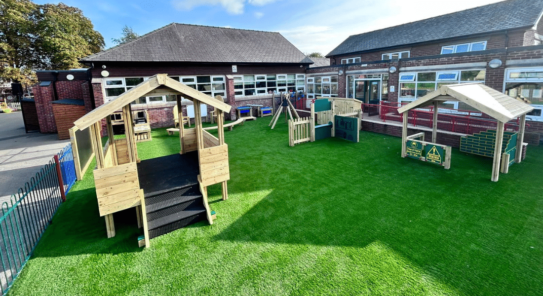 Artificial grass at an EYFS play area hosting several timber play structures