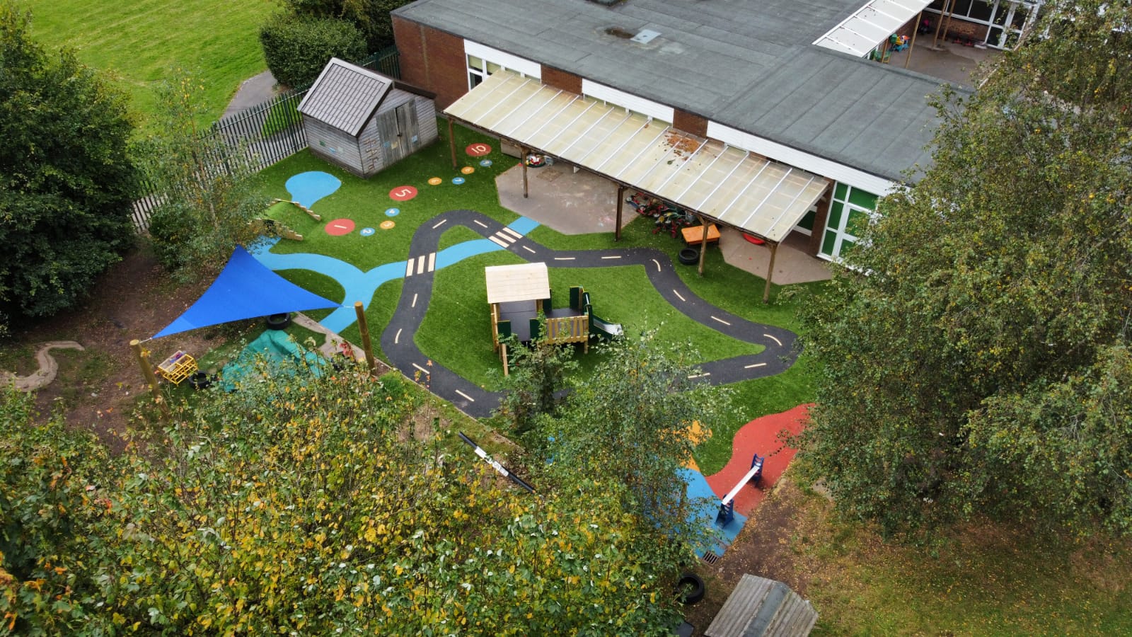 Shot from above looking down at a nursery play area designed to look like a road and river with timber structures