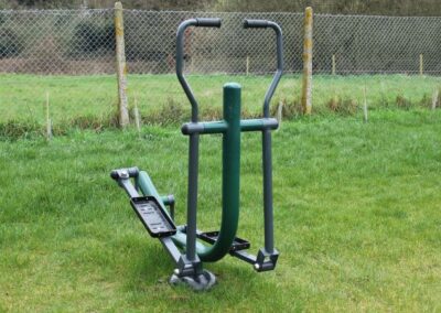 Green metal exercise equipment on grass