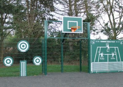 Green metal sports fence with basketball hoop