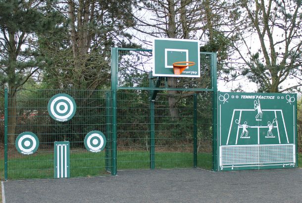 Green metal sports fence with basketball hoop