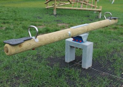 Round timber see-saw set on grass