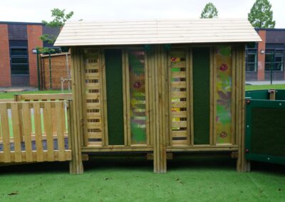 side view of a timber play tower which features multicoloured floral patterns