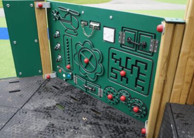 Green playboard featuring red movable parts