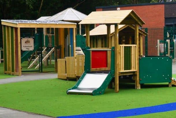 Grasshopper Play Tower and Sensory Tunnel sat on artificial grass