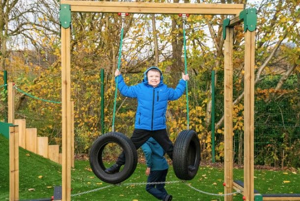 Child in blue on swing tyres