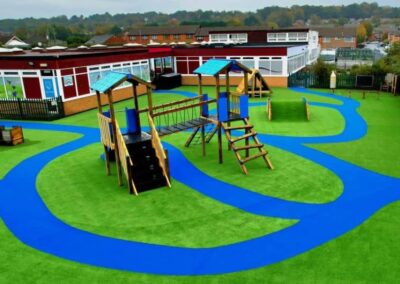 Arial image of St Peter's Catholic Primary School, featuring a timber playhouse, with a bespoke two tower timber play tower.
