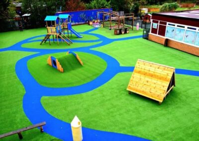 Arial image of St Peter's Catholic Primary School, featuring a timber playhouse, with a bespoke two tower timber play tower.