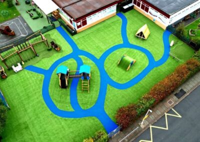 Arial image of St Peter's Catholic Primary School, featuring a timber playhouse, with a bespoke two tower timber play tower.