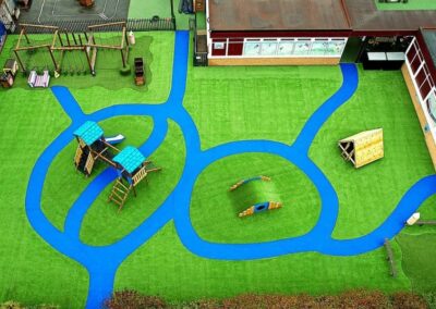 Arial image of St Peter's Catholic Primary School, featuring a timber playhouse, with a bespoke two tower timber play tower.