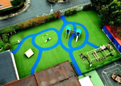 Arial image of St Peter's Catholic Primary School, featuring a timber playhouse, with a bespoke two tower timber play tower.
