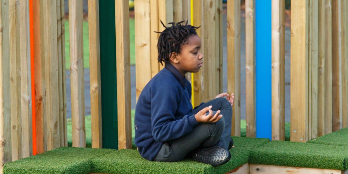 This image shows a male pupil meditating on the inclusive seating