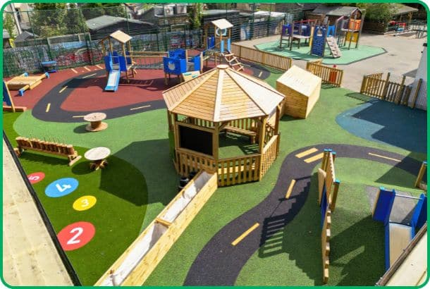 Overview of school playground featuring bright colours in surfacing and timber play structures