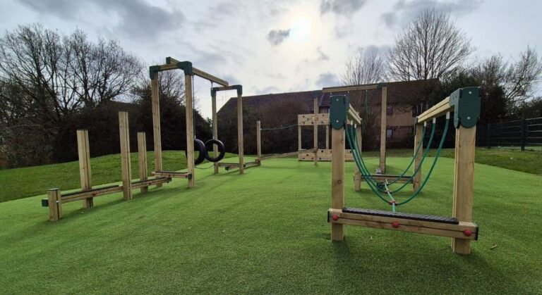 This image shows a Adventure Trail 8 U-Shapes with a open traverse wall pieces of playground equipment
