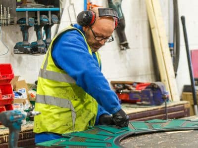 This image shows a Creative Play factory worker working on playtech