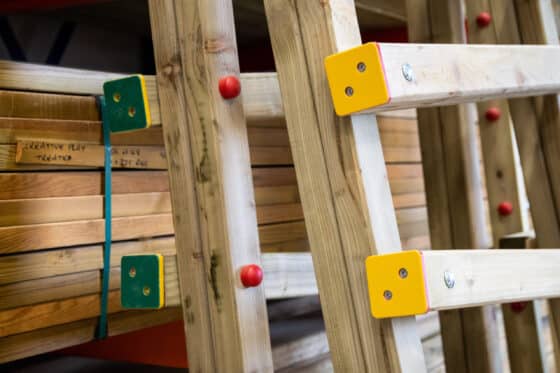 Close up of a wooden structure with green and yellow plastic ends