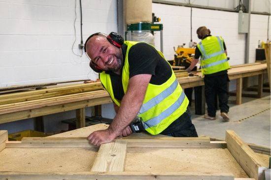 Net Zero Page Imagery This image shows a male factory working drilling timber wood pieces of playground equipment
