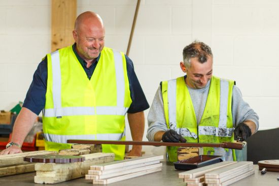This image shows two men in a work shop