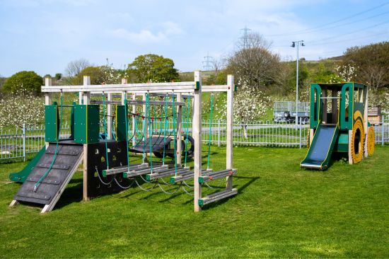 This image shows a dart activity centre and tractor at a commercial playground