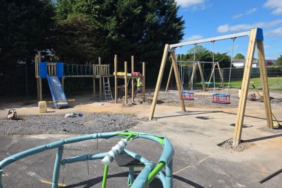 This image shows a construction team working on a new playground in the UK