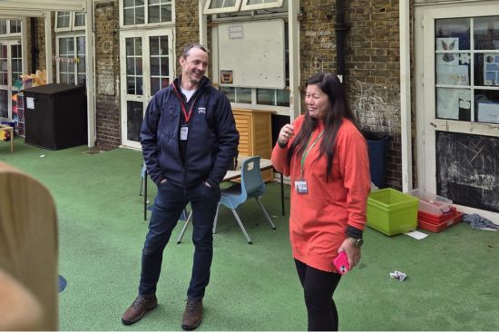 This image shows our Outdoor Play expert during a education consultation visit with a female head teacher 