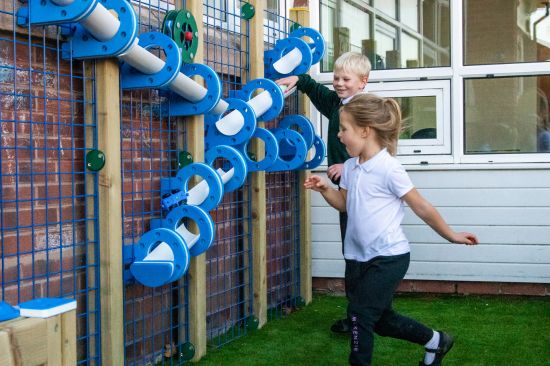 This image shows two primary children playing with water play sensory equipment 
