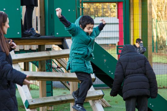 This image shows a child jumping of a play tower 