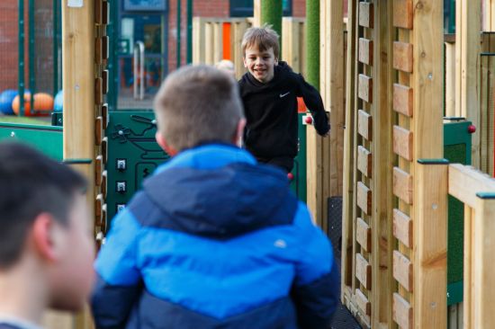 This image shows three children running up a playtower ramp