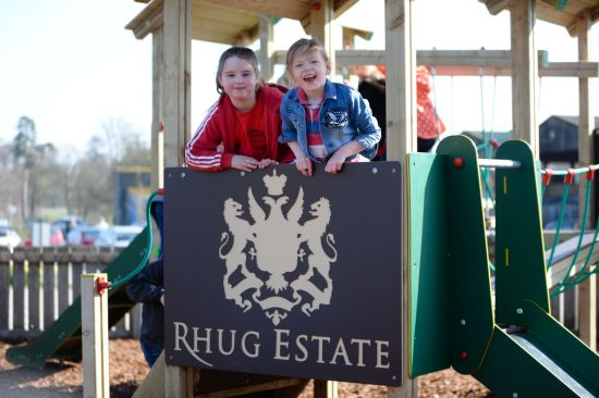 This image shows children on a playground tower which has been personalised with the estates coat of arms of the playtech material