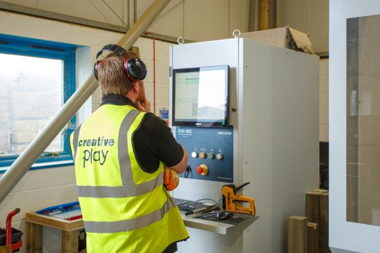 This image shows a factory worker using one of the three CNC we have at the Creative Play factory