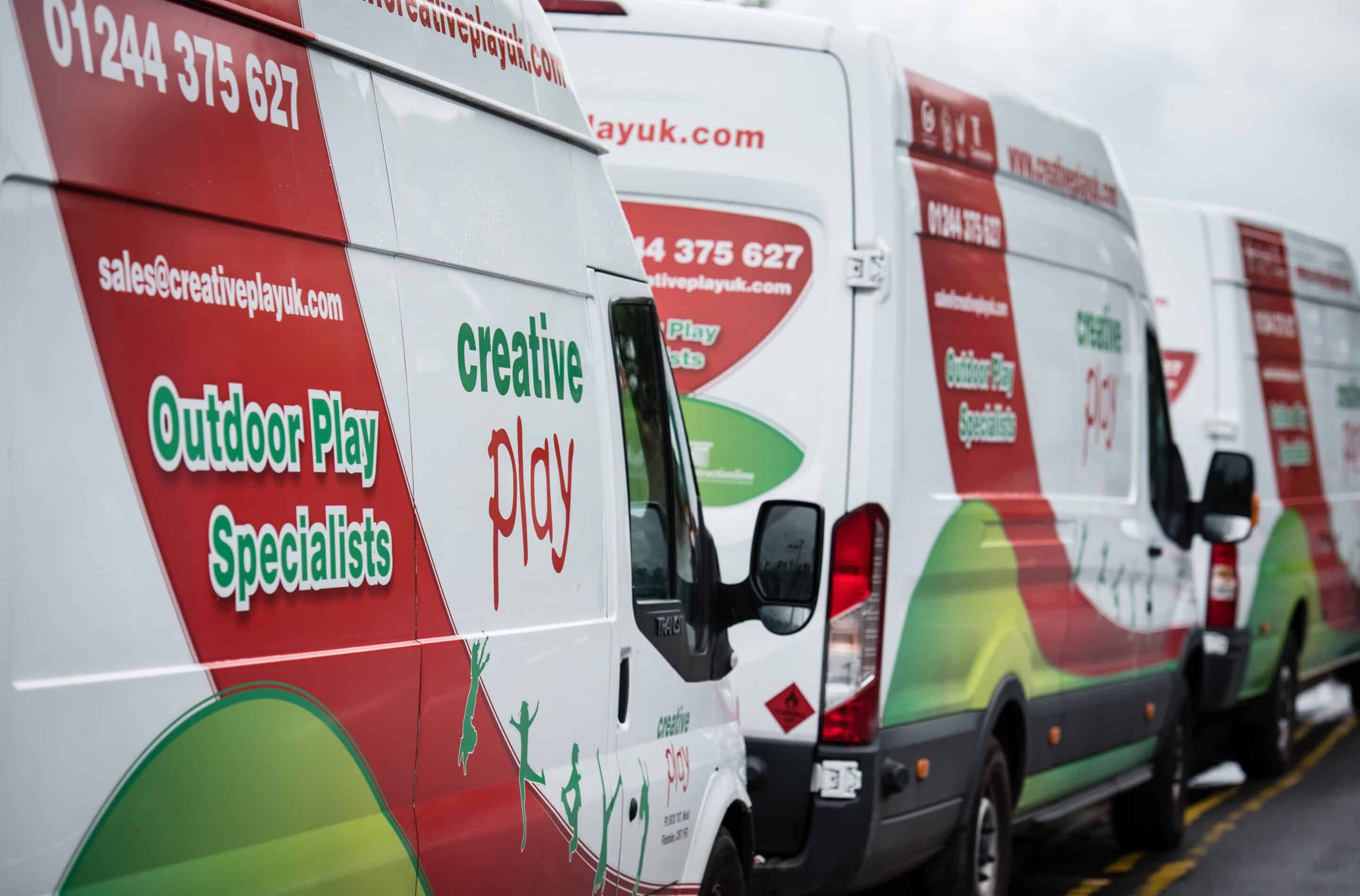 Fleet of 3 white vans with Creative Play logo on the side