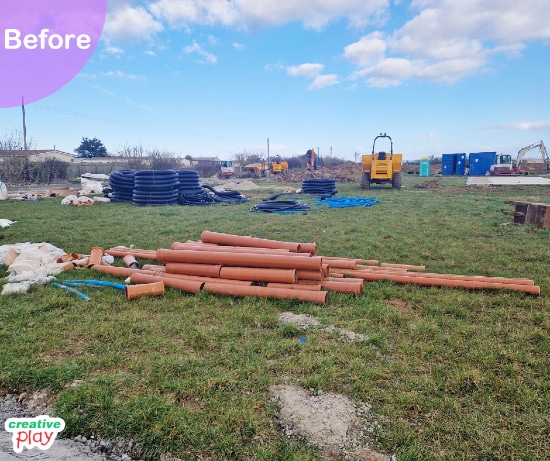 Construction site featuring pipes in a field