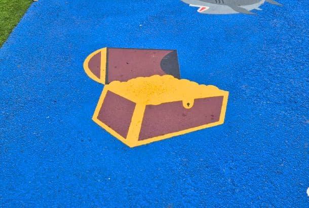 Treasure Chest This Image Shows A Brown And Yellow Pirate Treasure Chest Thermo Character On Blue Wetpour Safety Surfacing