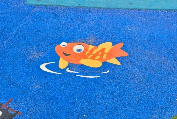 Fish 4 (1M) This Image Shows A Orange And Yellow Fish Thermo Character On Blue Wetpour Safety Surfacing