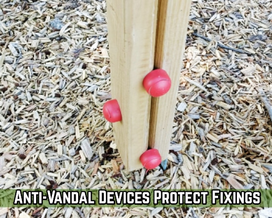 Red bobbles on a wooden post protecting fixings from vandals