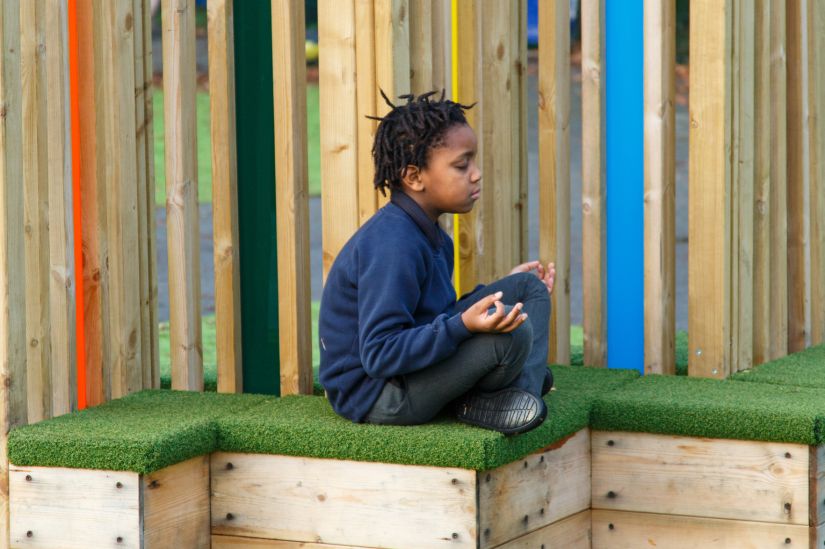 This image shows a male pupil meditating 