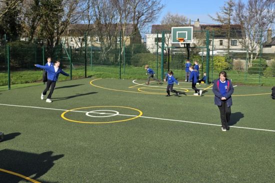 This is an image of children playing on a MUGA playground equipment 