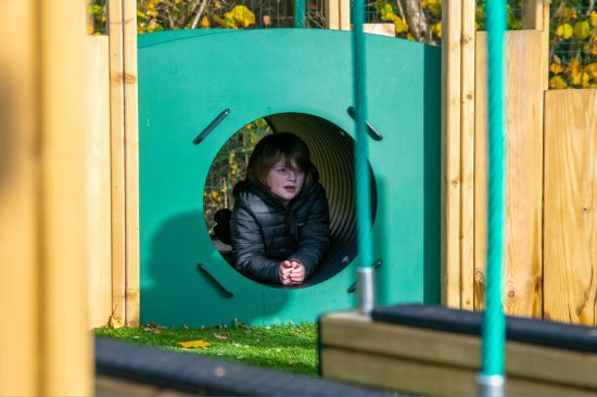 New Website Imagery - 2026 - Homepage This image shows a child crawling through a mound tunnel